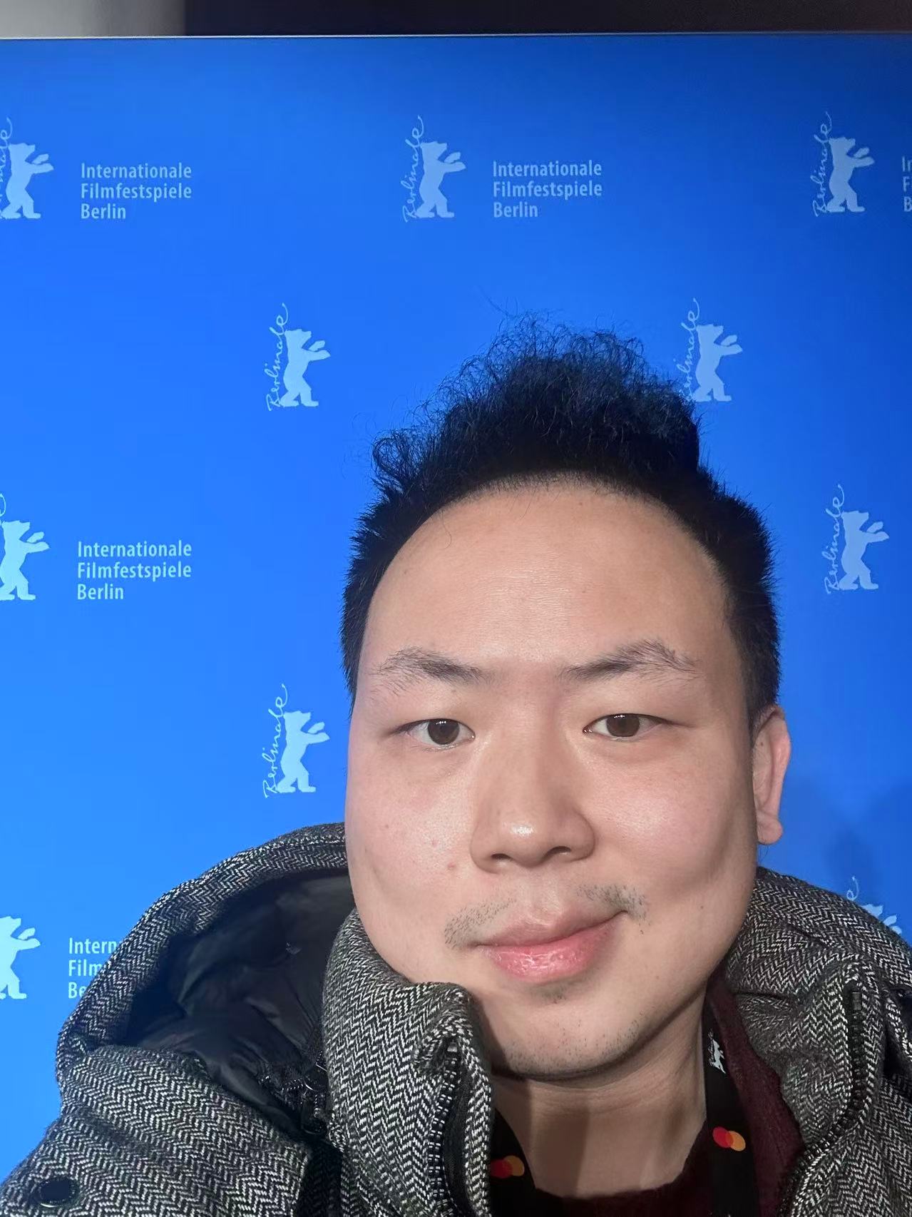 Jiatao Cui in front of the blue Berlinale festival backdrop