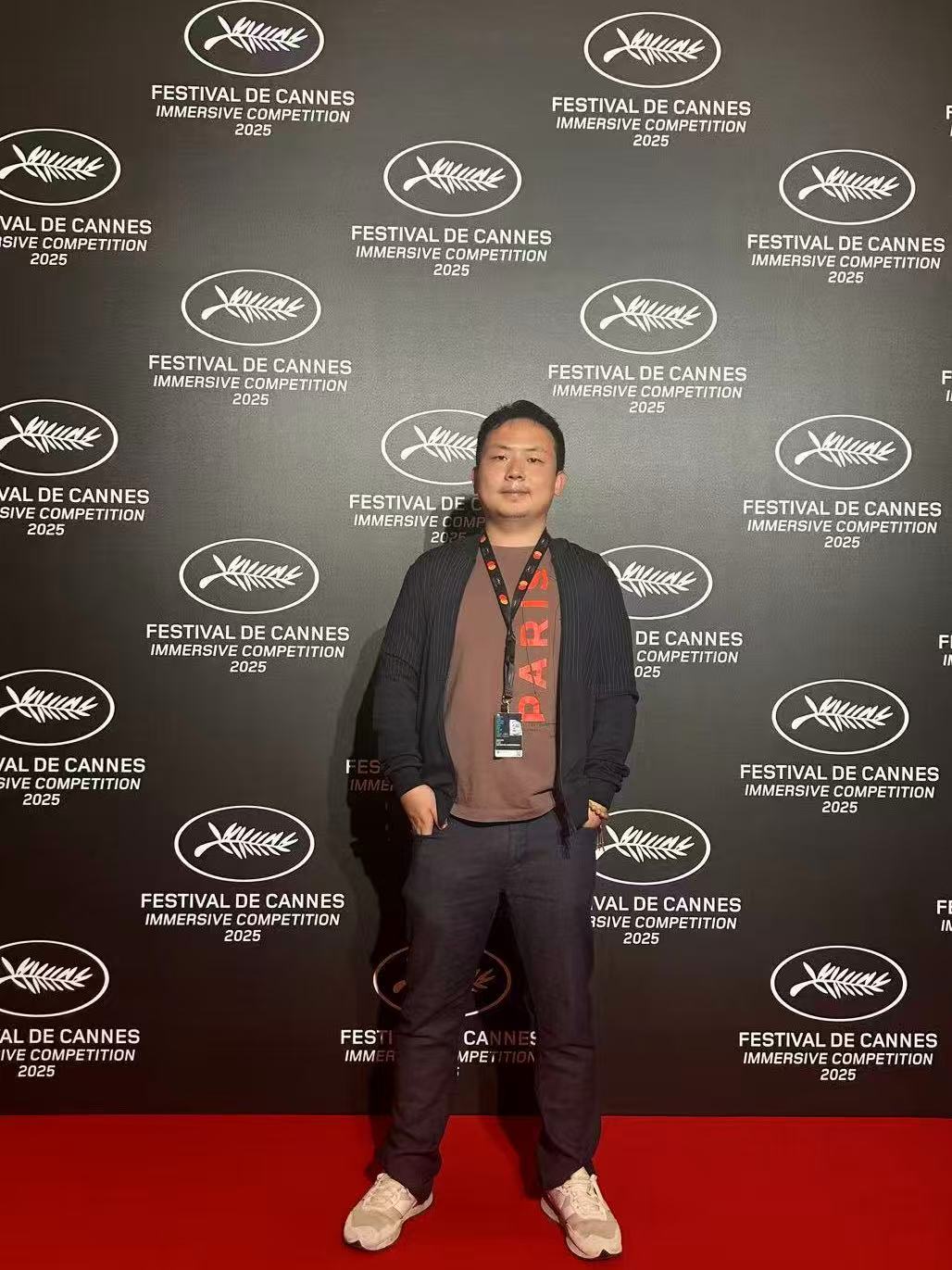 Jiatao Cui in front of the Festival de Cannes Immersive Competition 2025 backdrop